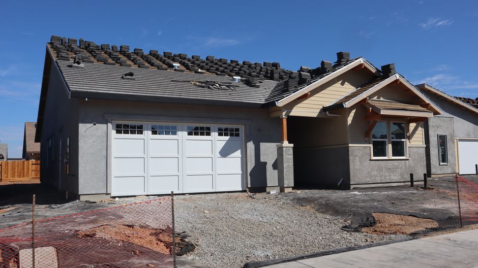 House exterior with a tiled roof against a clear sky.