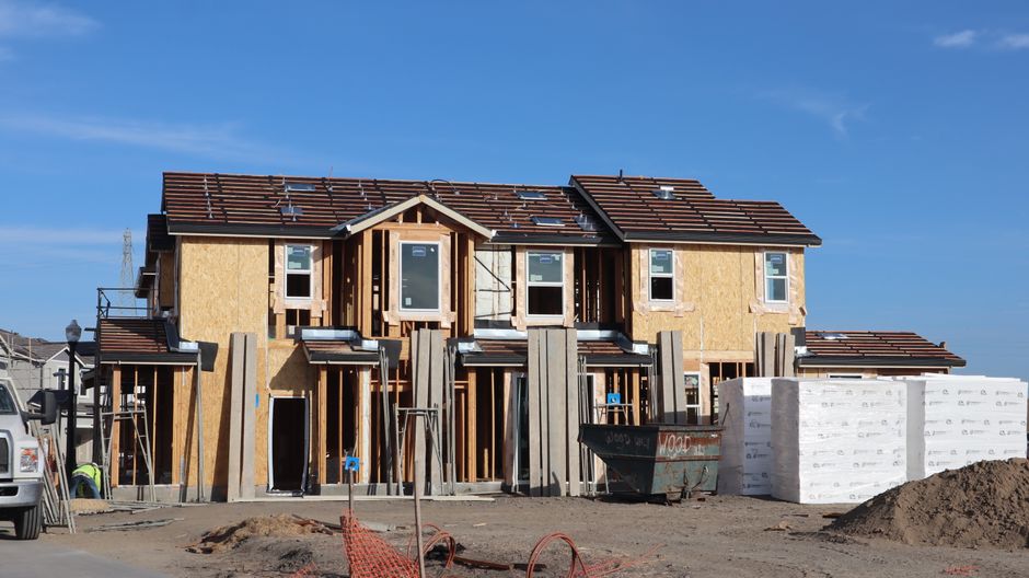 Front view of a two-story house with clear blue skies.