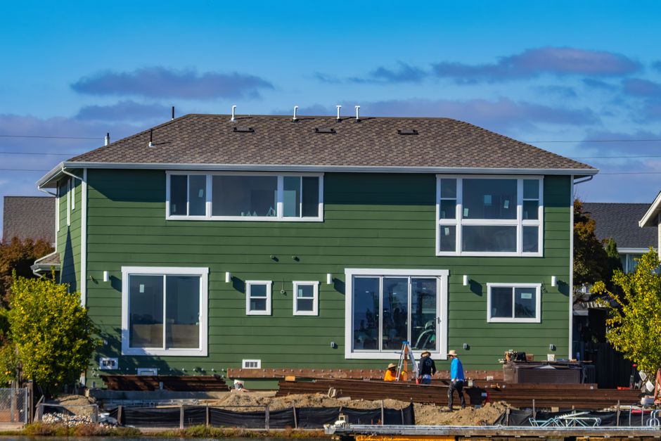 Green house exterior with workers outside.